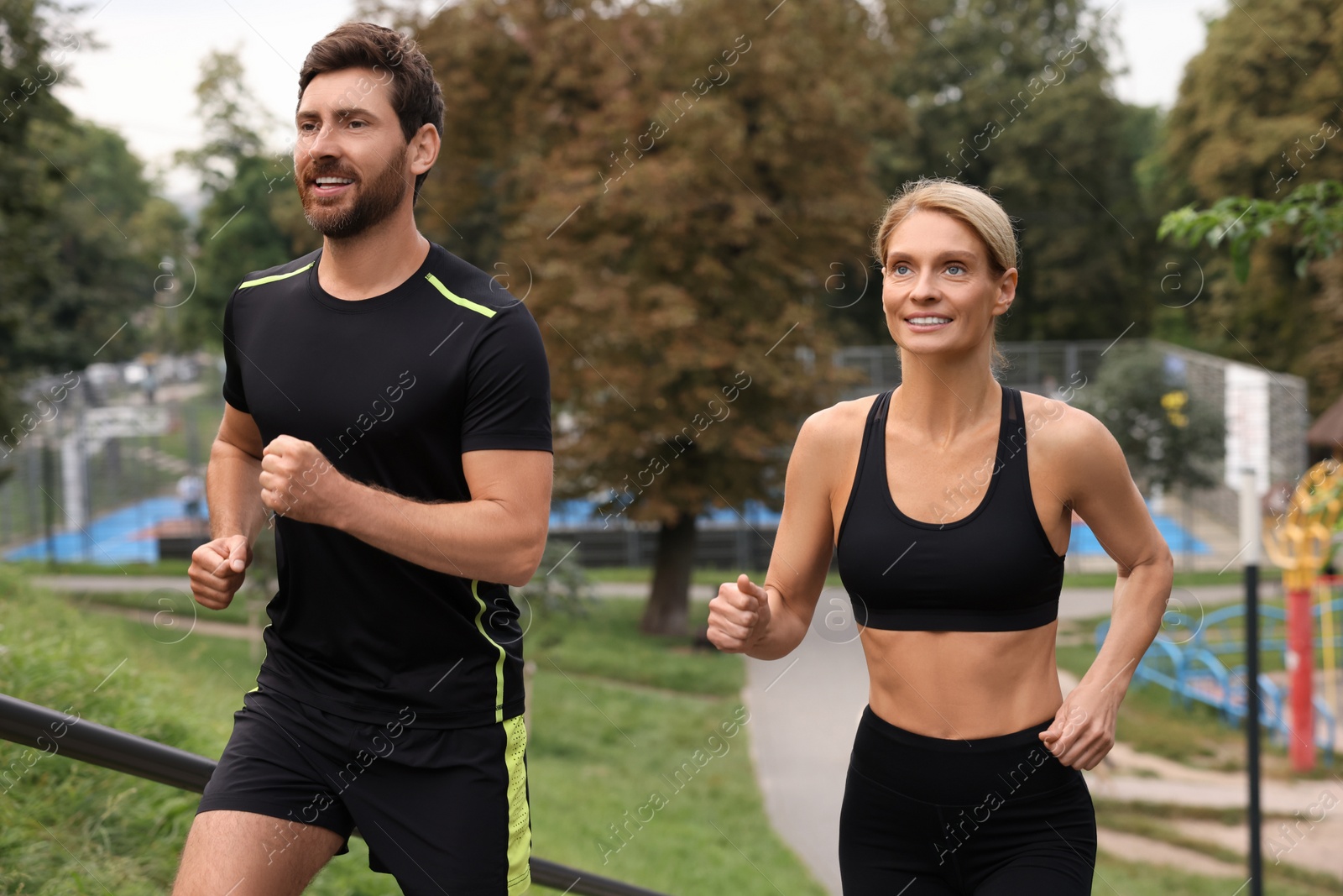 Photo of Healthy lifestyle. Happy couple running in park