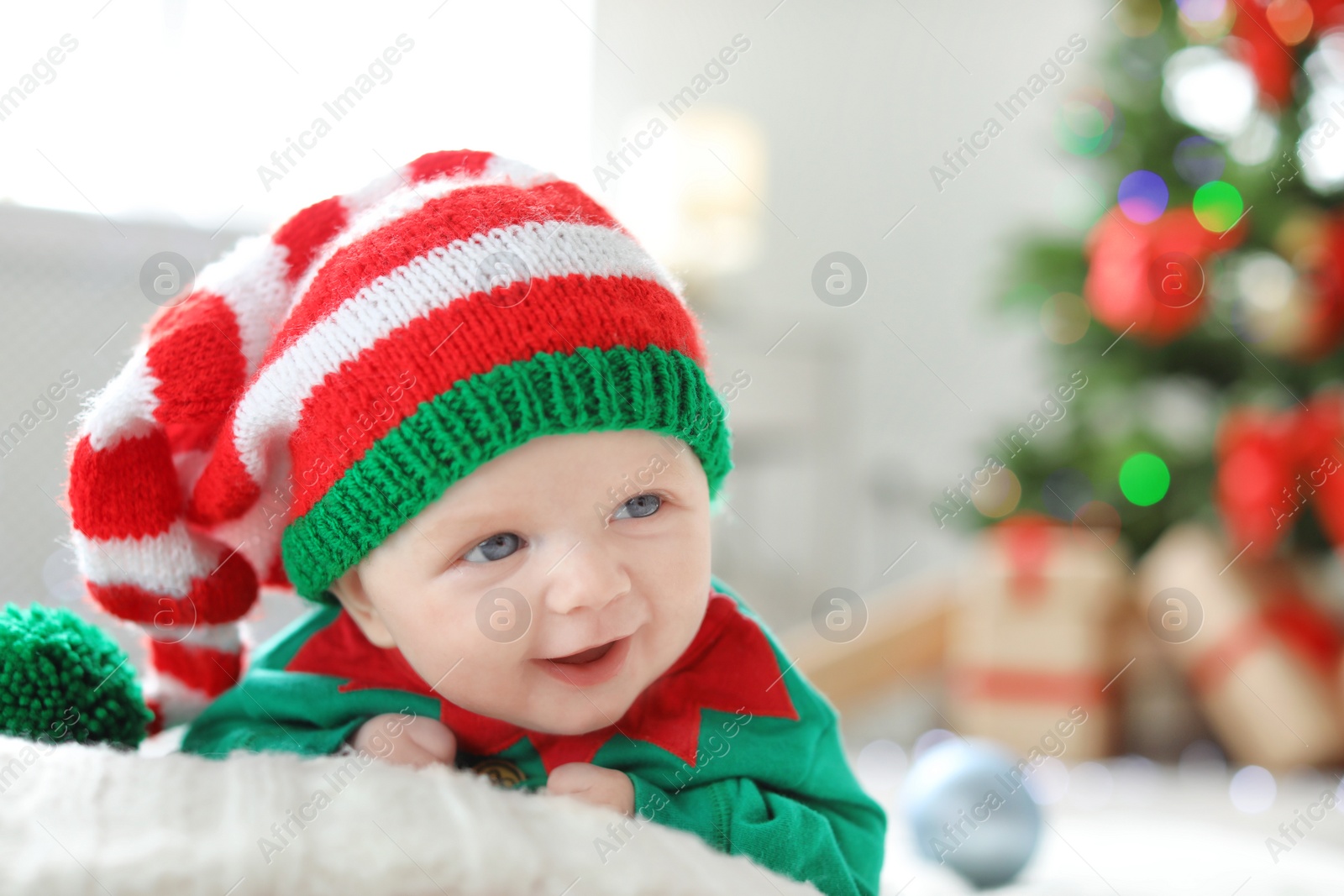 Photo of Cute baby in Christmas costume at home