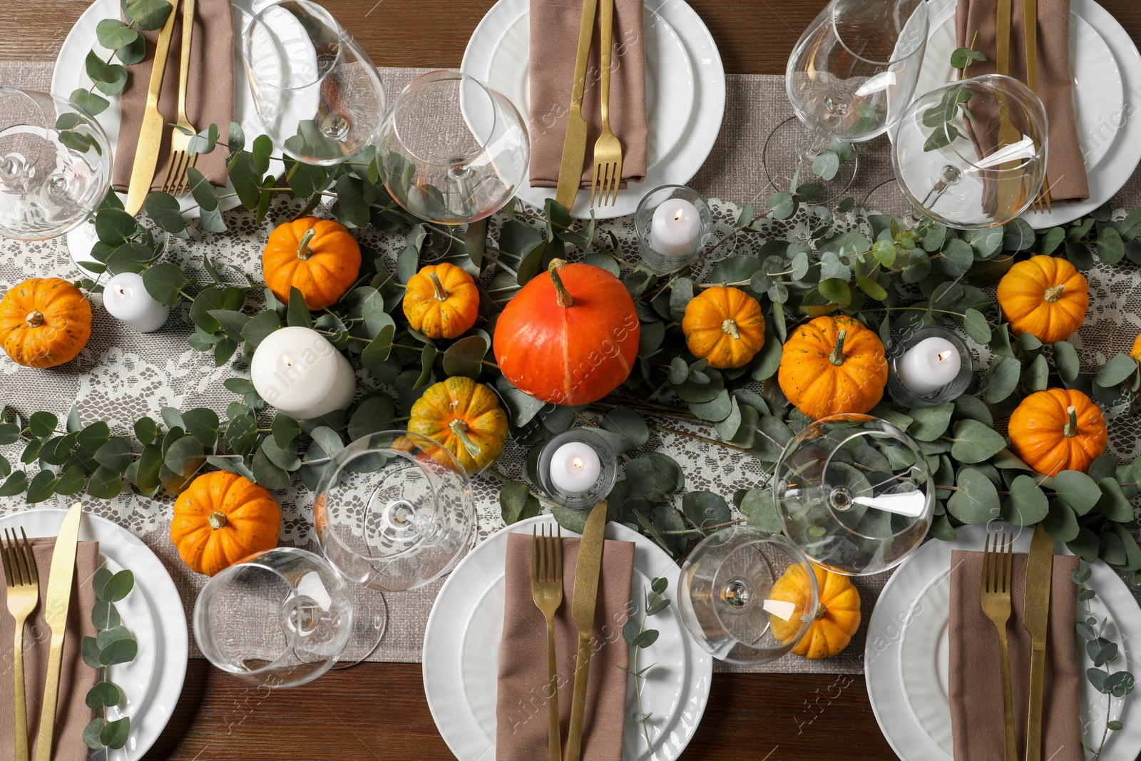 Photo of Beautiful autumn table setting. Plates, cutlery, glasses, pumpkins and floral decor, flat lay