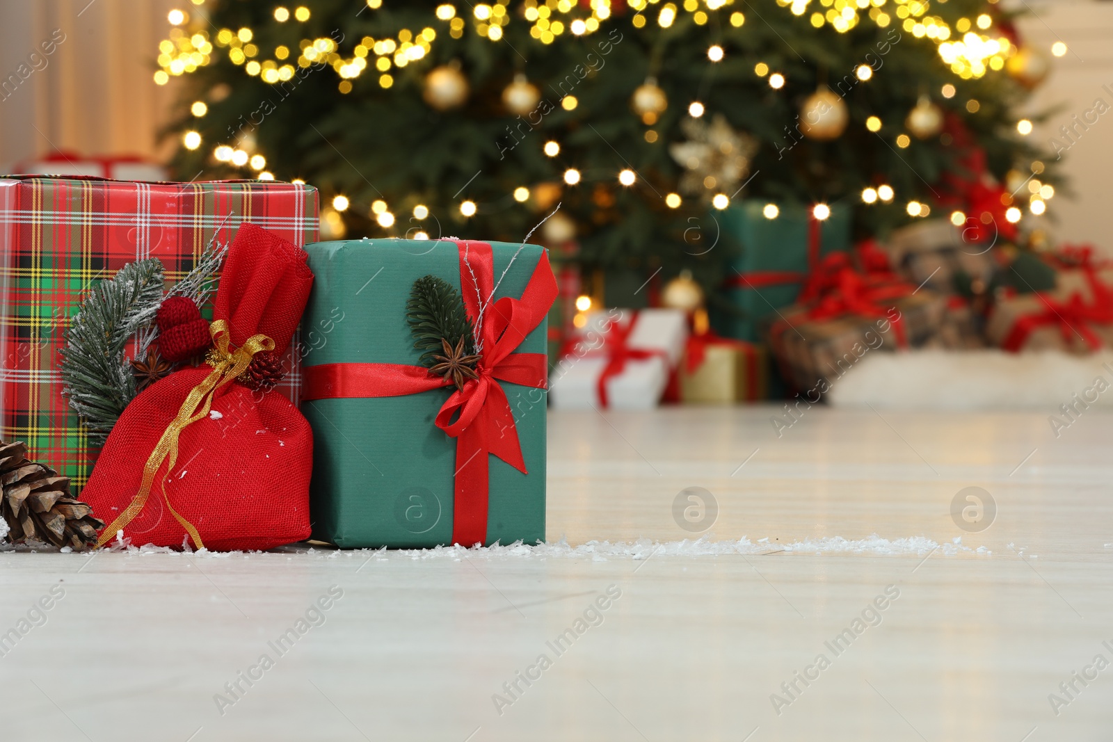 Photo of Gifts on floor near Christmas tree in room, space for text