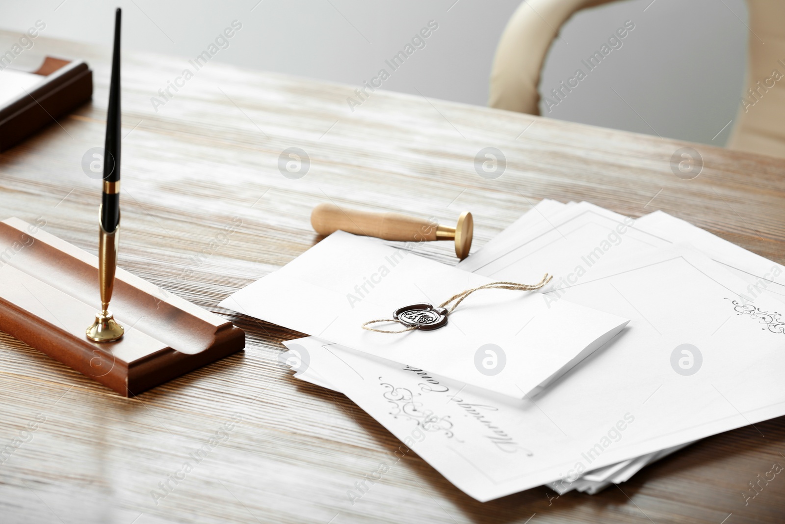 Photo of Notary stamp, pen and documents on wooden table in office