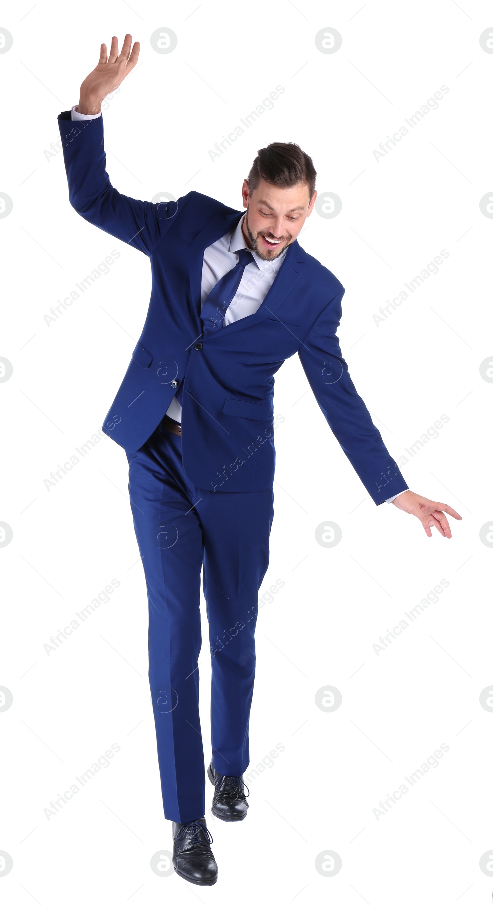 Photo of Full length portrait of businessman balancing on white background