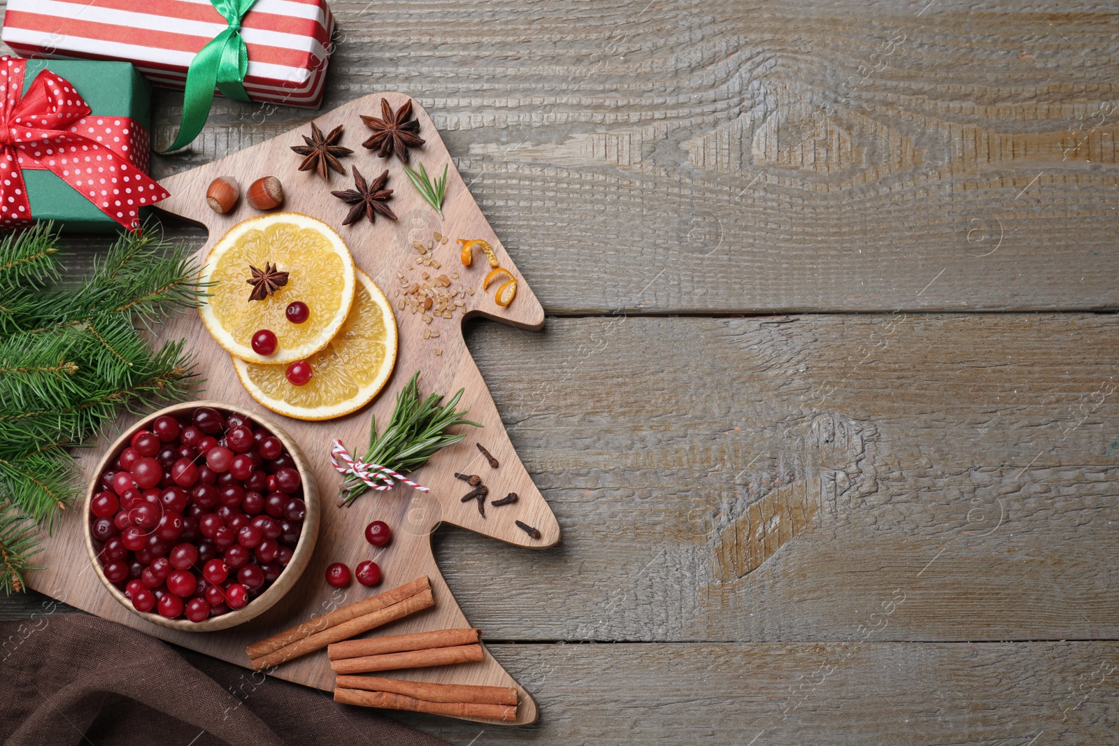 Photo of Flat lay composition with fresh ripe cranberries on wooden table. Space for text