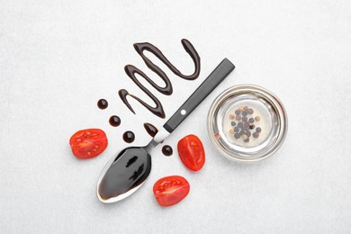 Photo of Organic balsamic vinegar and cooking ingredients on white table, flat lay