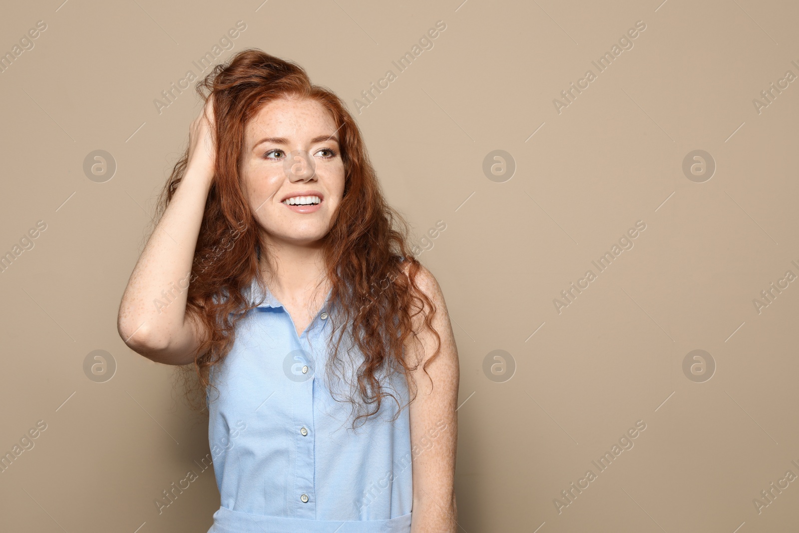 Photo of Portrait of young woman with beautiful face on beige background. Space for text