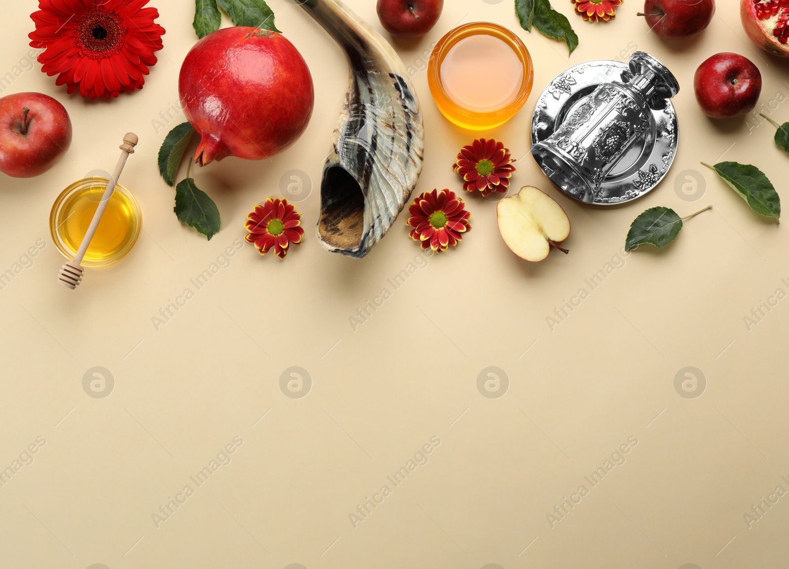 Photo of Flat lay composition with Rosh Hashanah holiday attributes on beige background. Space for text