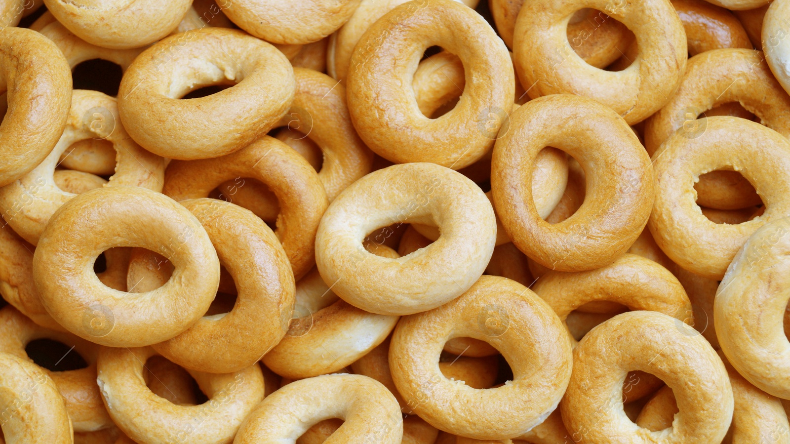 Photo of Tasty dry bagels (sushki) as background, top view
