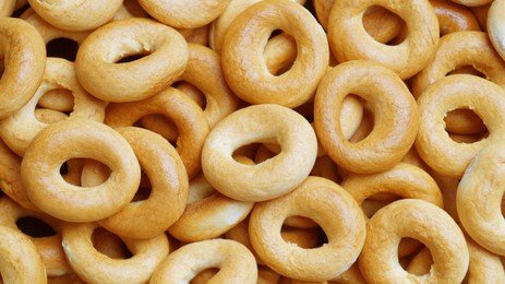 Photo of Tasty dry bagels (sushki) as background, top view