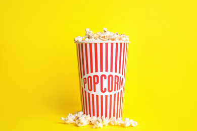 Tasty fresh pop corn on yellow background