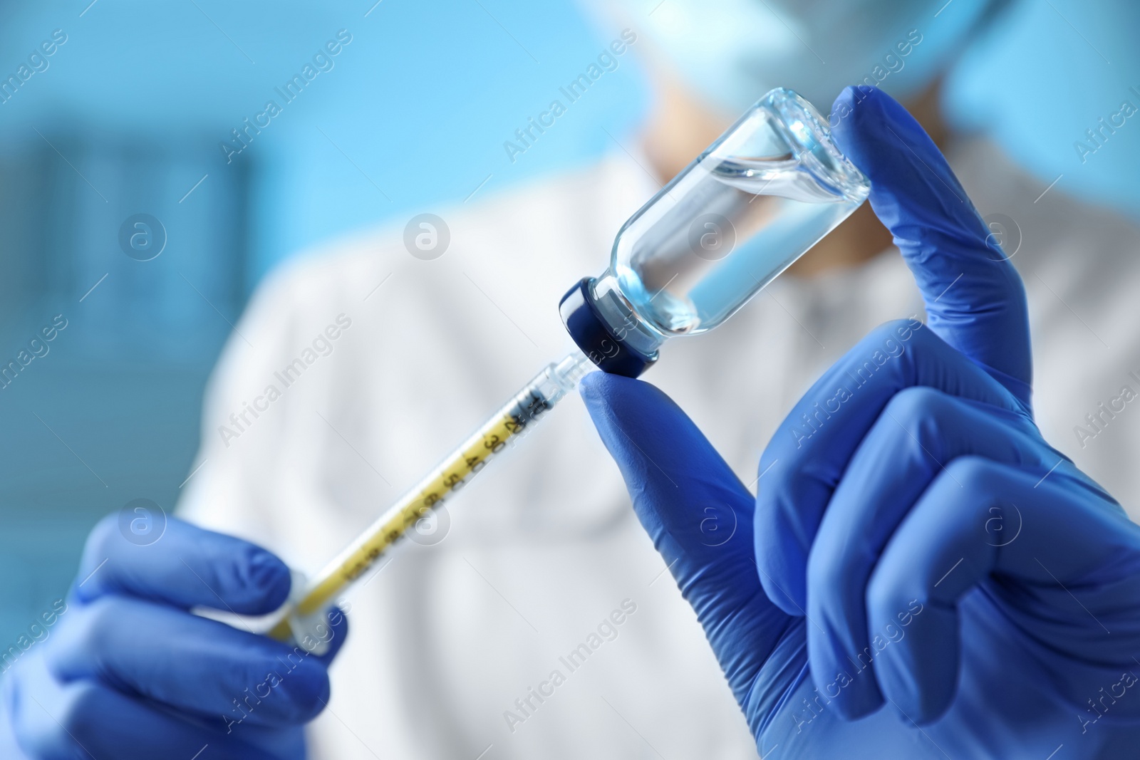 Photo of Doctor filling syringe with medication in clinic, closeup. Vaccination and immunization