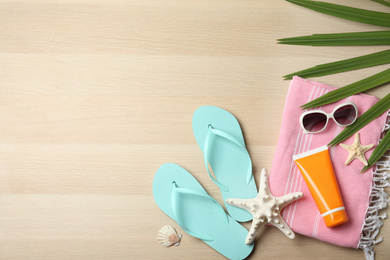 Photo of Flat lay composition with beach objects on wooden background. Space for text