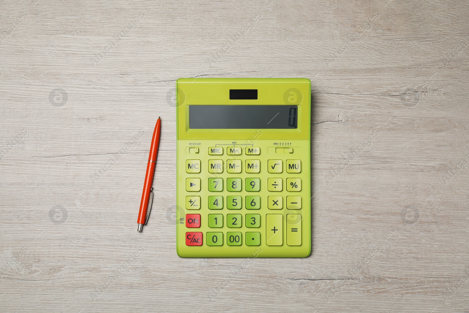 Photo of Calculator and pen on wooden table, top view