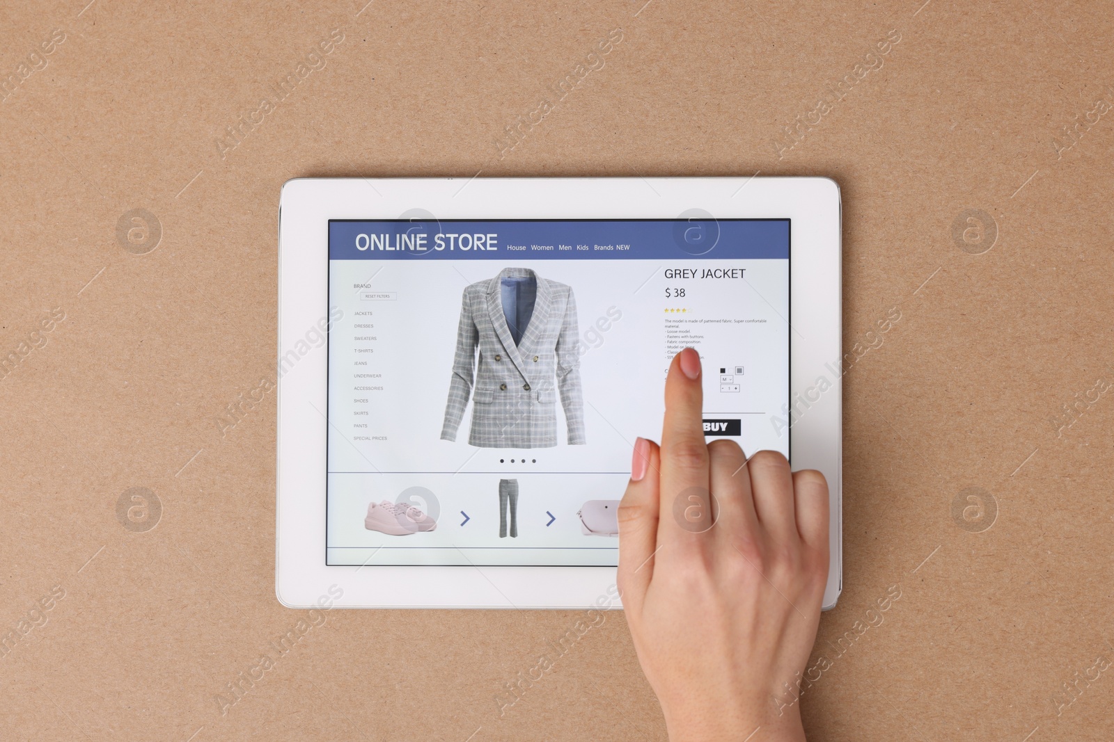 Photo of Woman with tablet shopping online on light brown background, top view