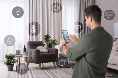 Man using smart home control system via application on mobile phone indoors. Different icons around him