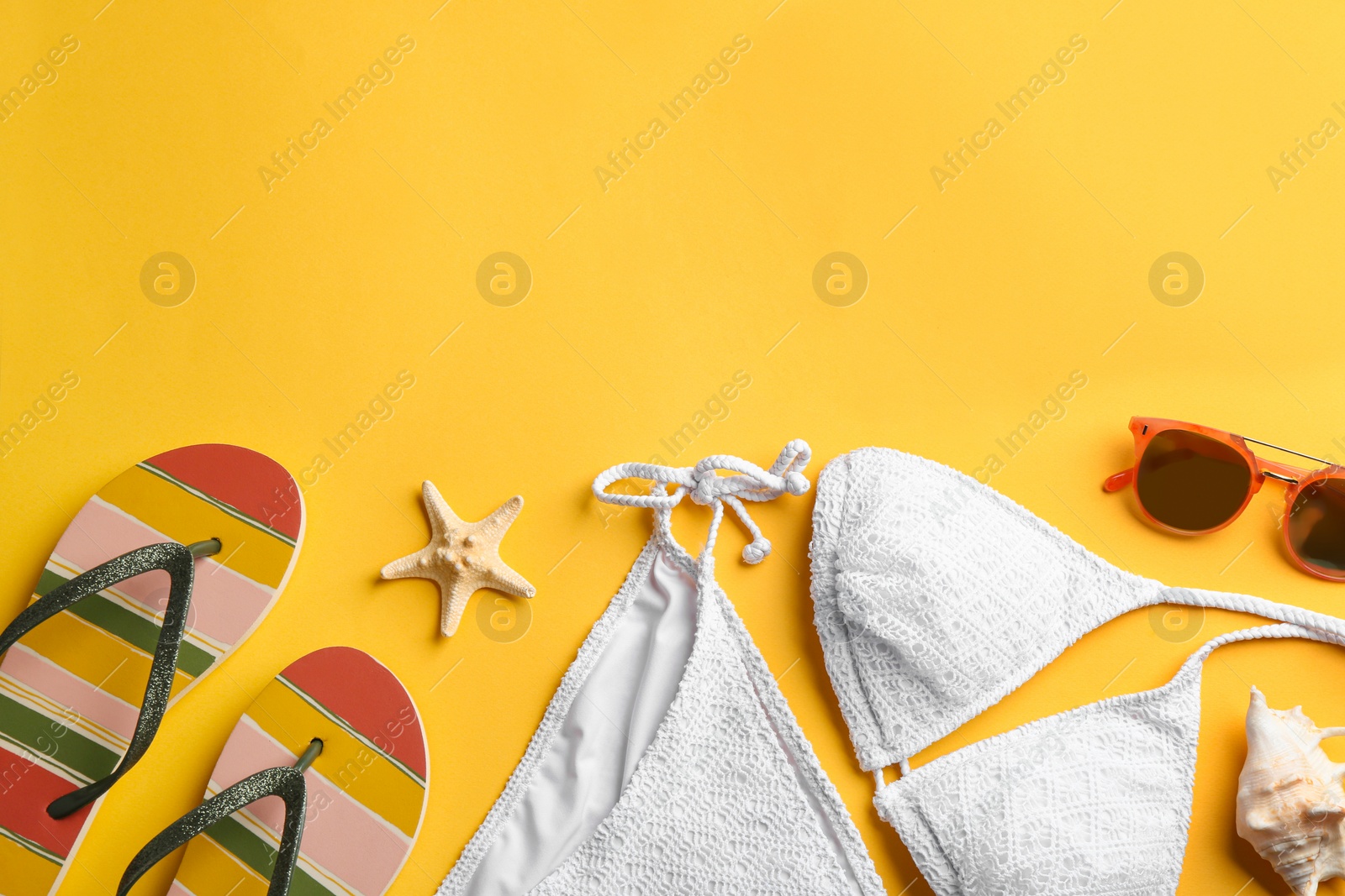 Photo of Flat lay composition with beach accessories on color background. Space for text