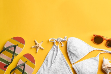 Flat lay composition with beach accessories on color background. Space for text