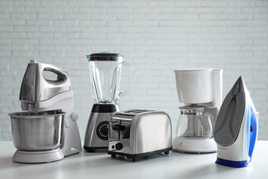 Photo of Set of modern home appliances on white table