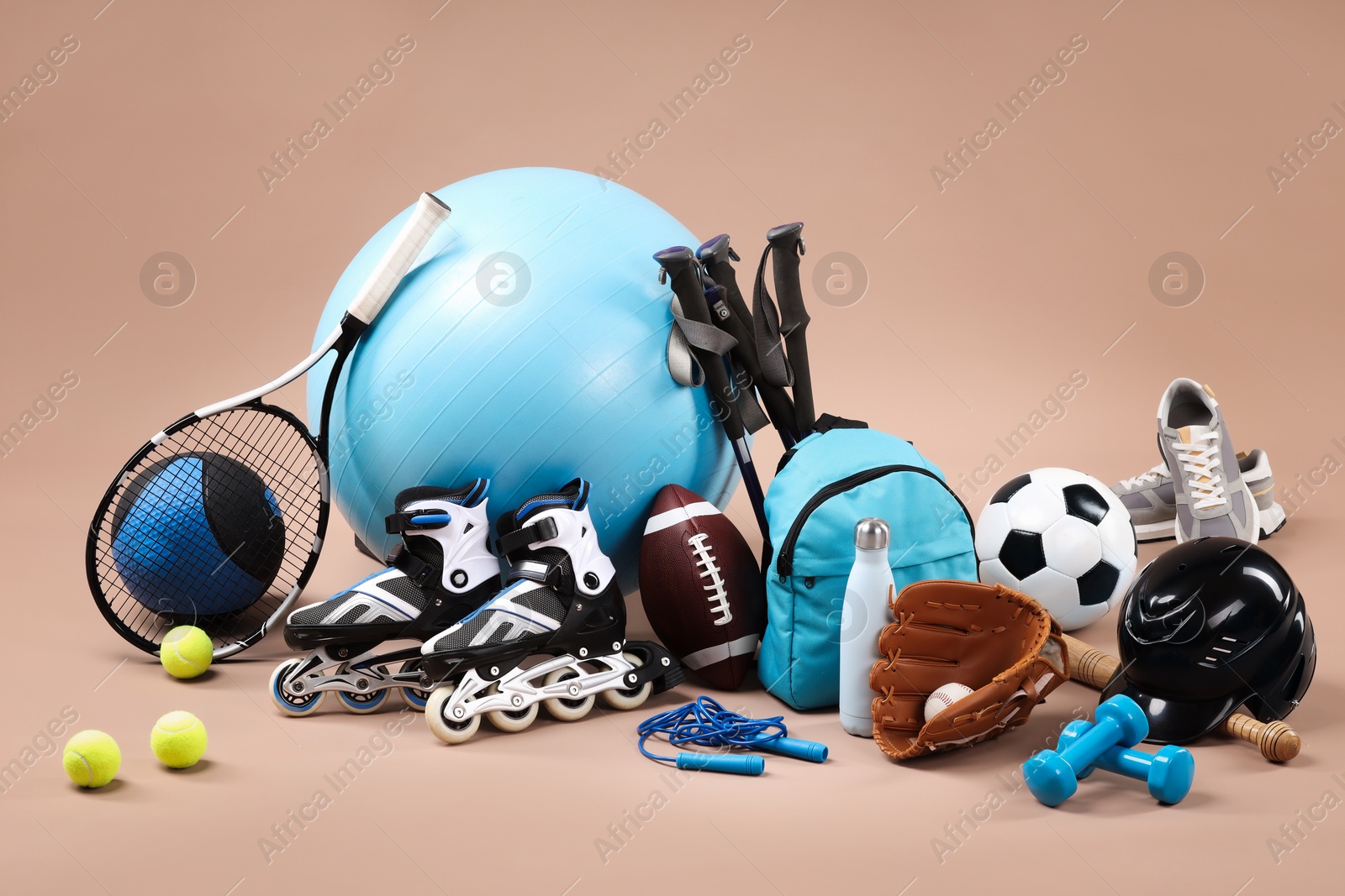 Photo of Many different sports equipment on beige background