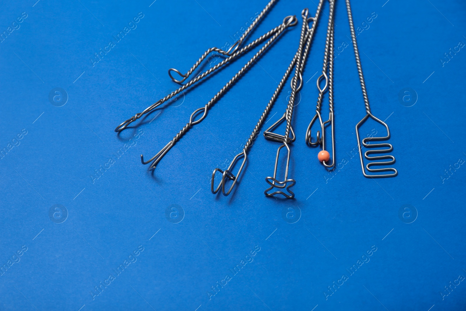 Photo of Set of logopedic probes for speech therapy on blue background. Space for text