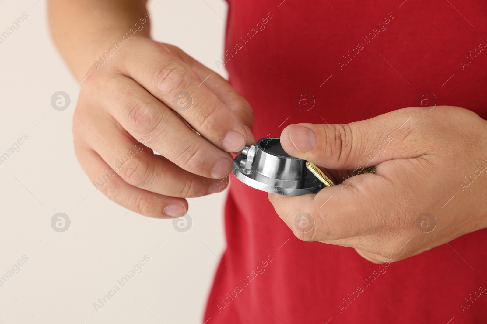 Photo of Worker holding screw and pipe fitting for installation, closeup