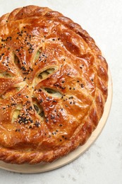 Tasty homemade pie with filling on light table, top view