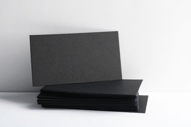 Photo of Blank black business cards on white background. Mockup for design