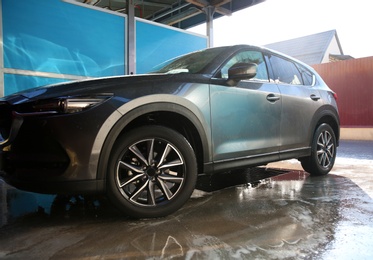 Photo of Clean wet automobile at professional car wash