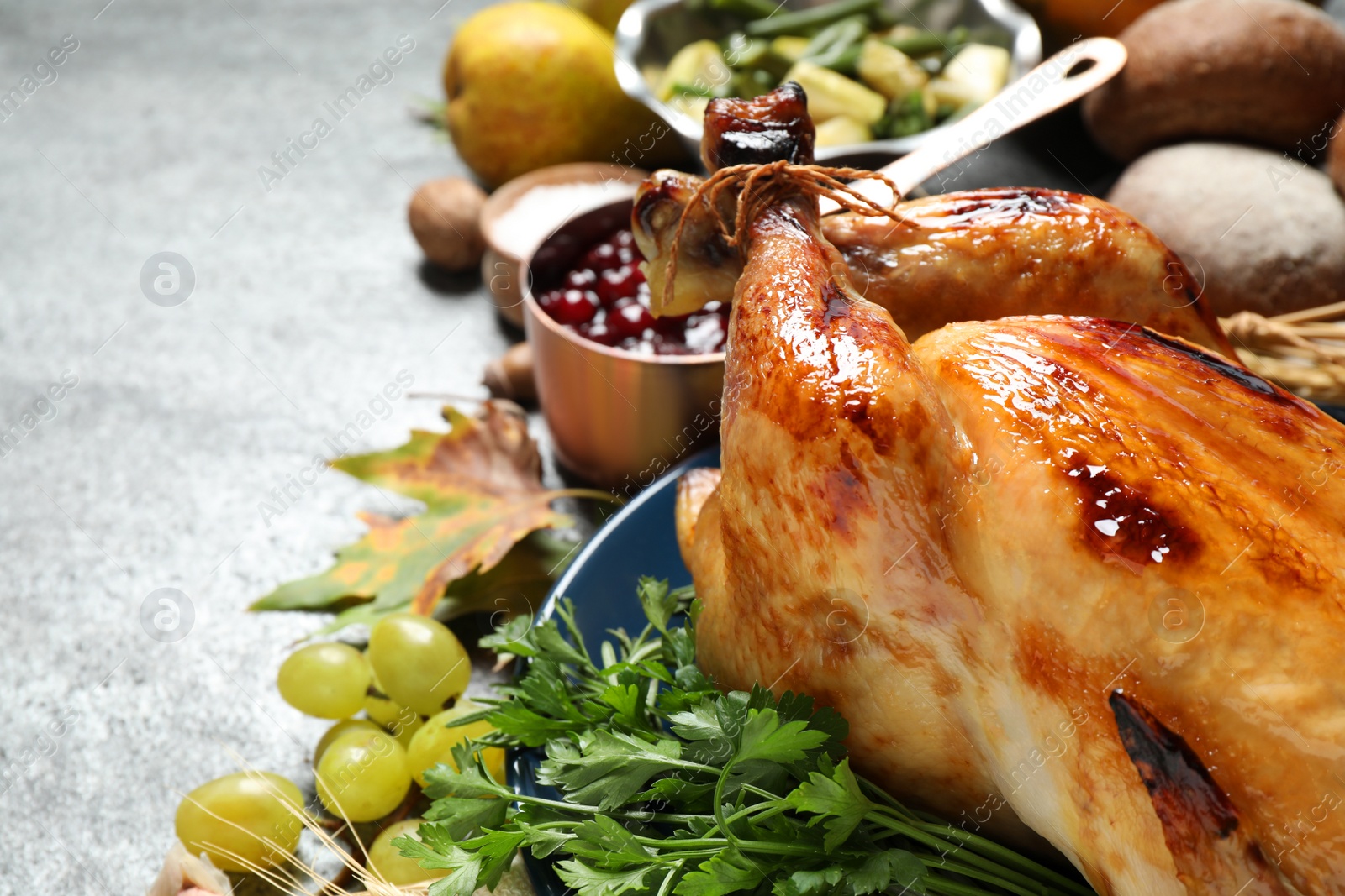 Photo of Composition with delicious turkey on grey background, closeup. Happy Thanksgiving day