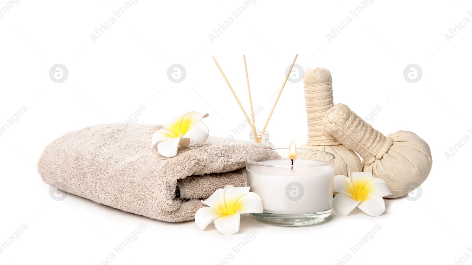 Photo of Beautiful spa composition with candle and herbal bags on white background