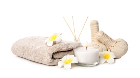 Photo of Beautiful spa composition with candle and herbal bags on white background