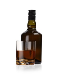 Photo of Glass and bottle of whiskey isolated on white