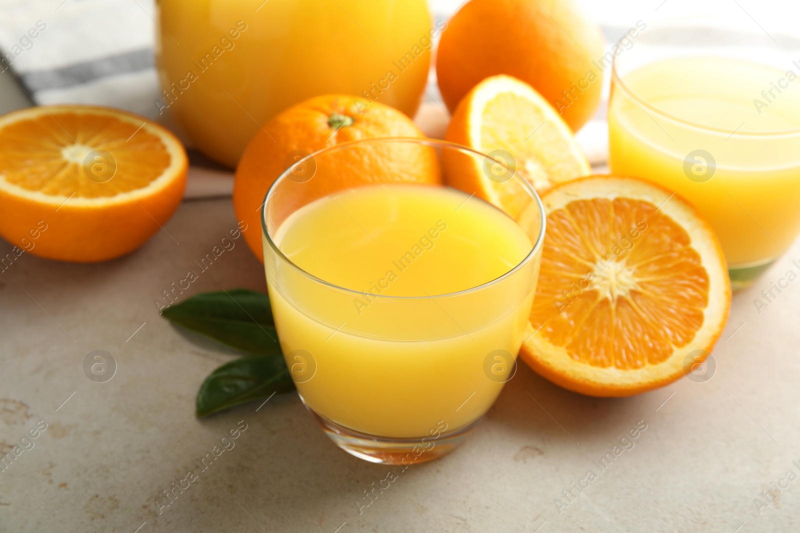 Photo of Composition with orange juice and fresh fruit on light background