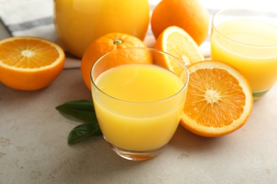 Photo of Composition with orange juice and fresh fruit on light background