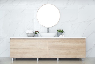 Modern bathroom interior with stylish mirror and vessel sink