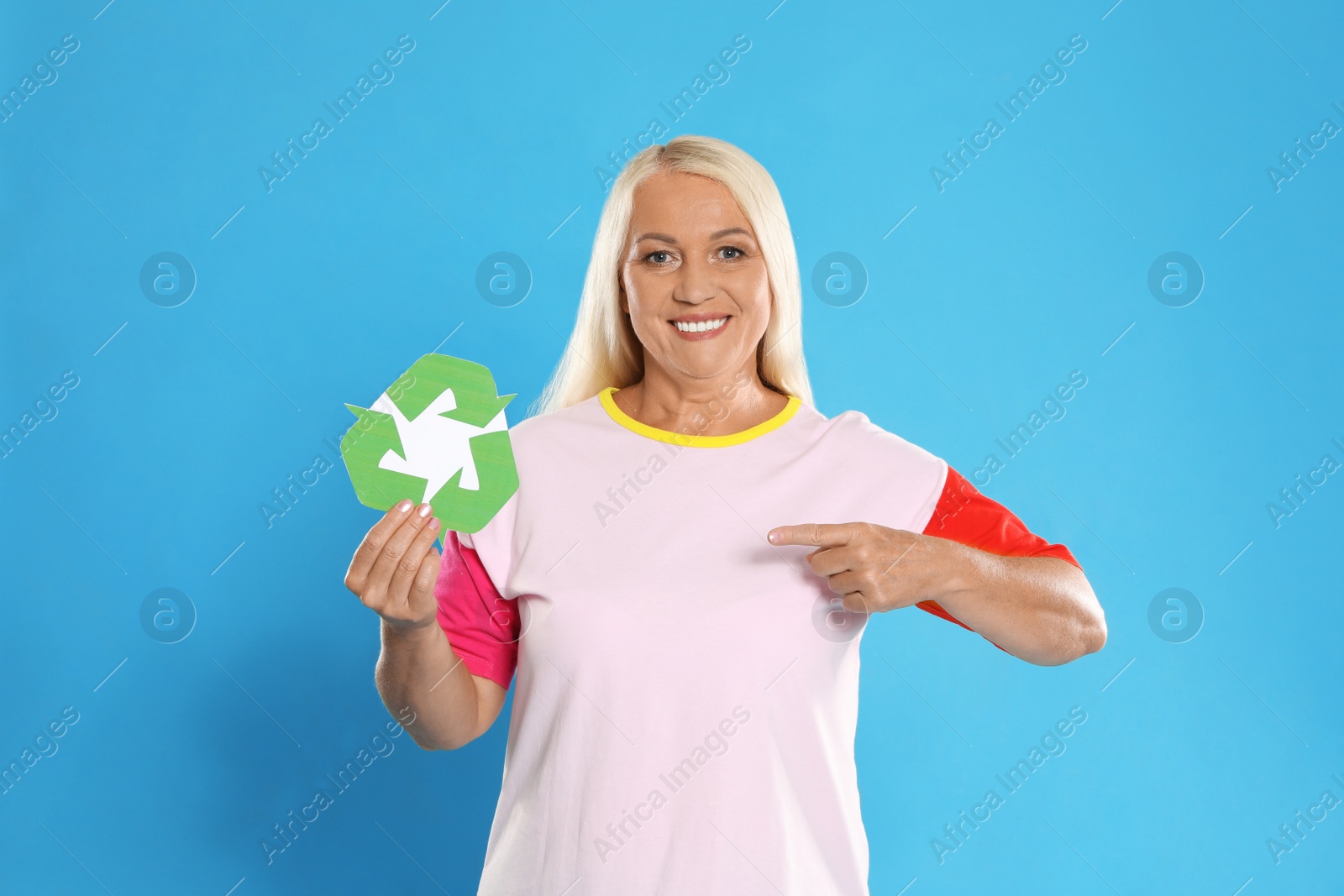 Photo of Woman with recycling symbol on blue background