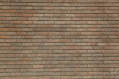 Photo of Texture of brown brick wall as background