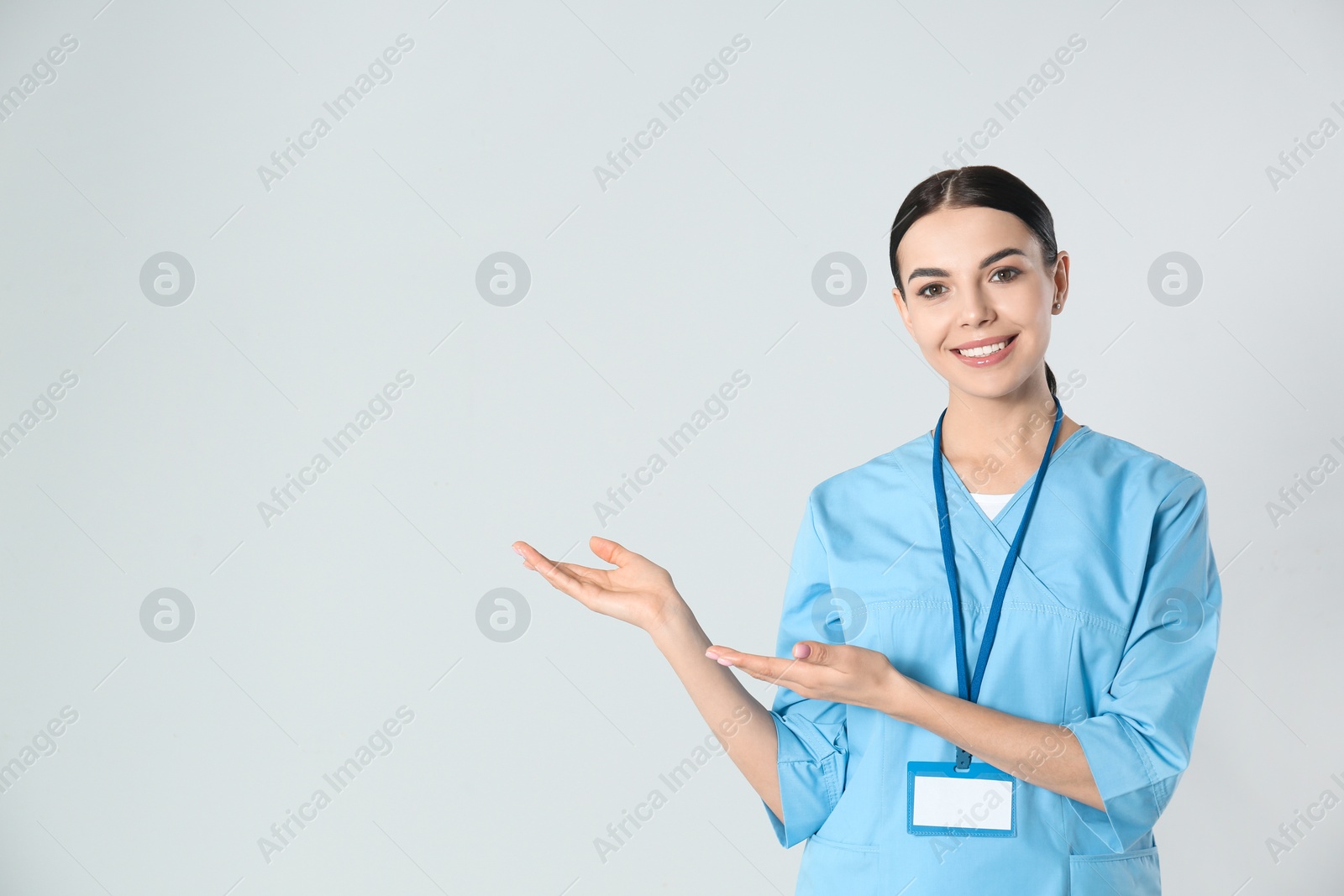 Photo of Portrait of young doctor against light background