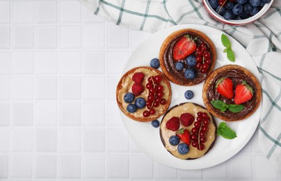 Photo of Fresh rice cake and rusks with different toppings served on white table, flat lay. Space for text