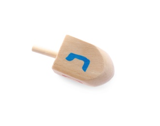 Photo of Wooden Hanukkah traditional dreidel with letter Nun isolated on white, top view