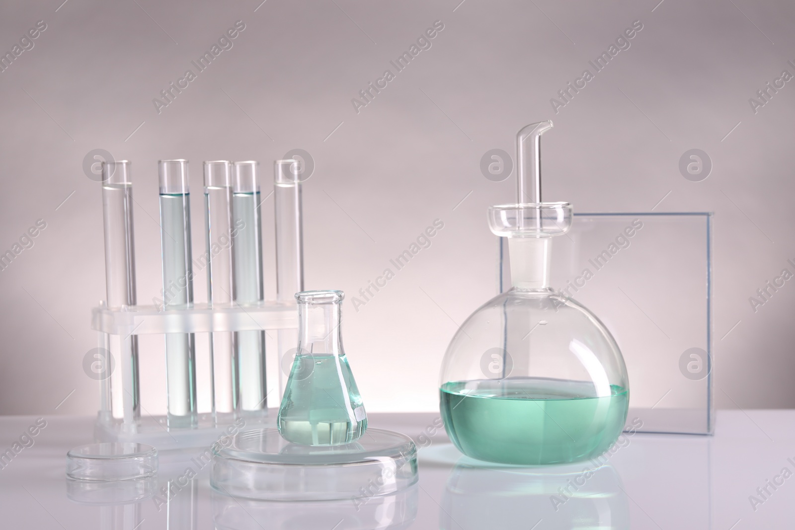 Photo of Laboratory analysis. Different glassware on table against light background