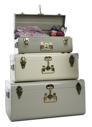 Photo of Stylish storage trunks with clothes and boots on white background. Interior elements
