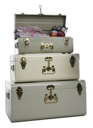 Stylish storage trunks with clothes and boots on white background. Interior elements