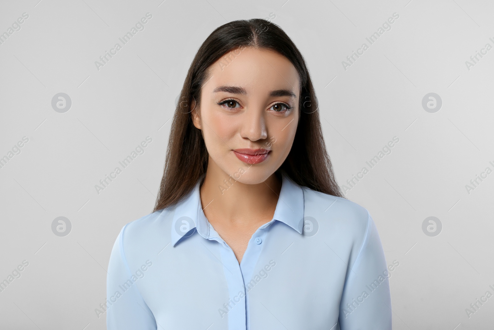 Photo of Portrait of beautiful young woman on light grey background