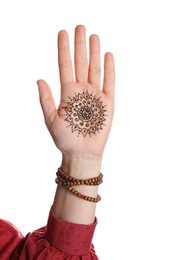 Woman with beautiful henna tattoo on hand against white background, closeup. Traditional mehndi