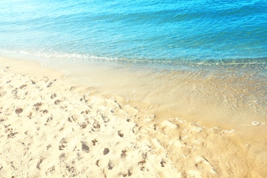 Sandy beach near sea on sunny day