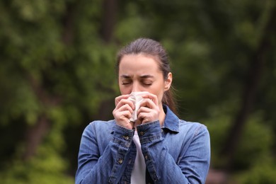 Photo of Woman suffering from seasonal spring allergy outdoors