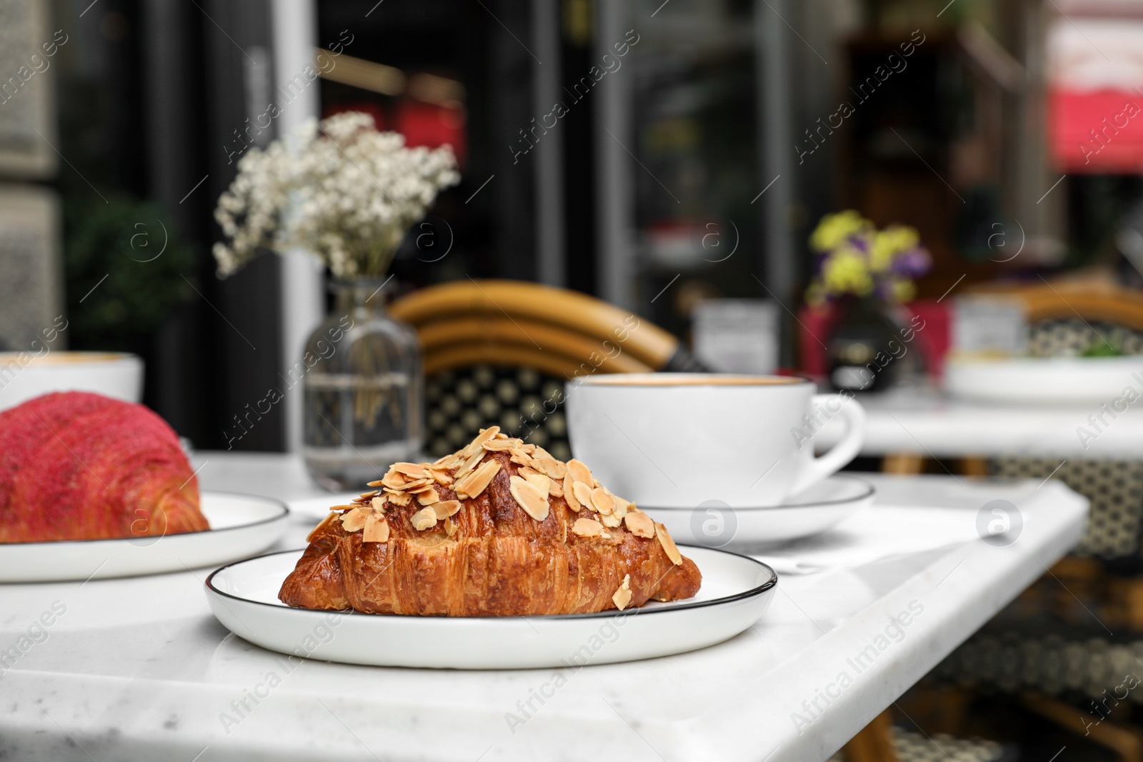 Photo of Delicious croissants on white marble table in cafe