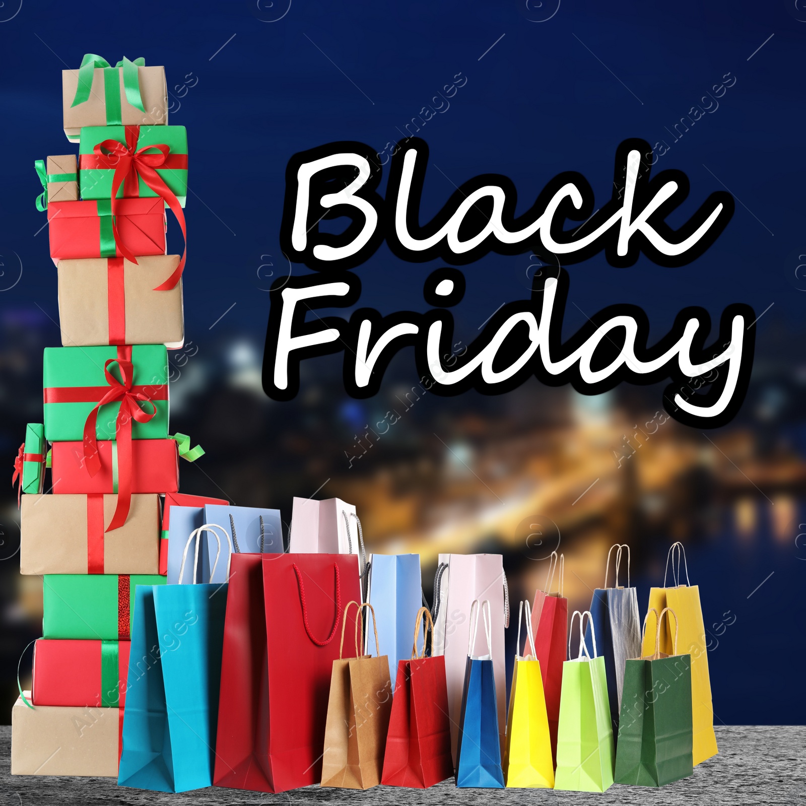 Image of Black Friday. Many shopping bags with gift boxes and blurred cityscape on background