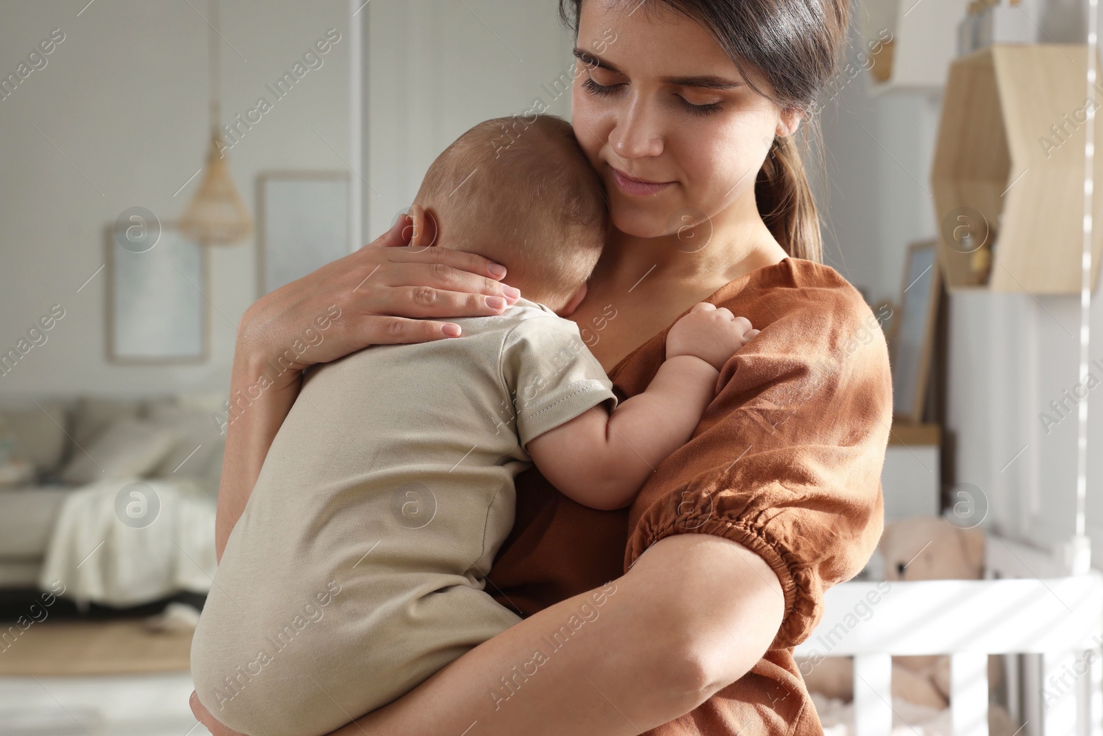 Photo of Happy young mother with her baby at home