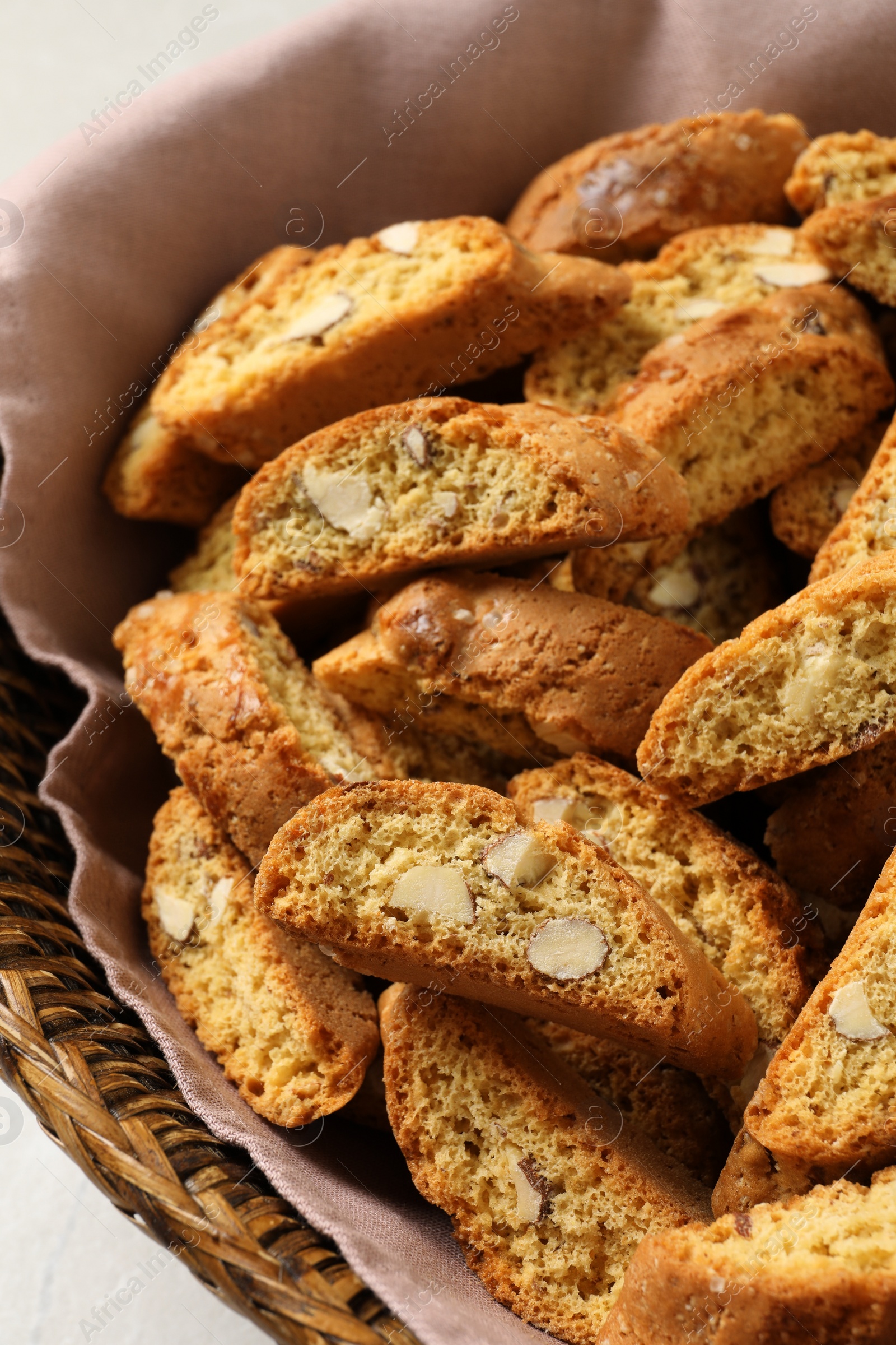 Photo of Traditional Italian almond biscuits (Cantucci) in basket, closeup